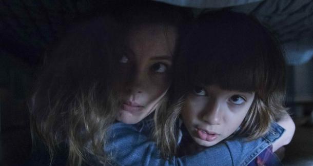 Sarah and her son Oliver hide under a bed in "Come Play"